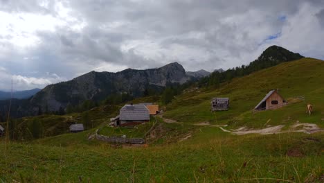 timelapse filmed on top of a mountain called krstenica in the slovenian mountains in the alps with surrounding houses, mountains, and animals