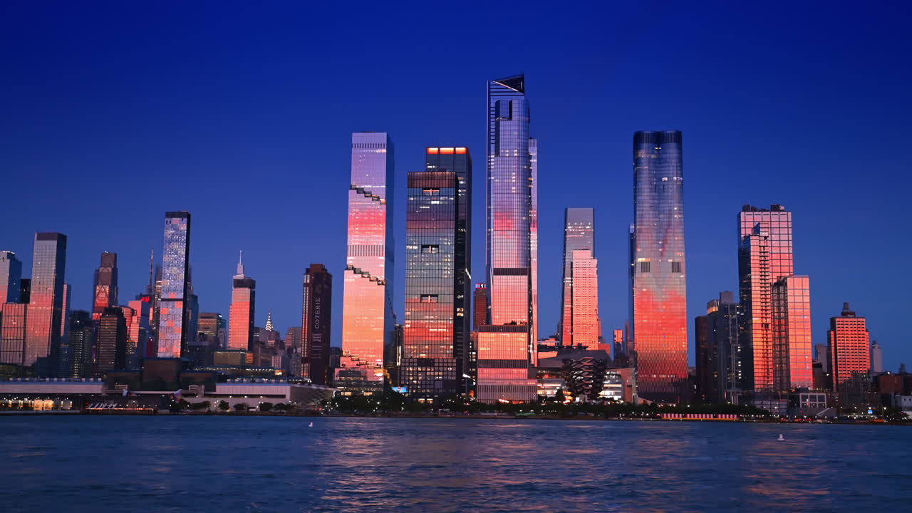 Hudson Yards skyscrapers at sunset Manhattan. New York Hudson Yards skyscrapers glowing at sunset with reflections
