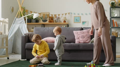 toddler boy playing with brother and mom