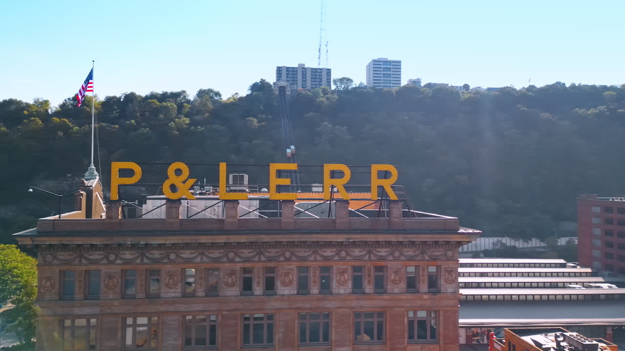 Pittsburgh, USA, 2 August 2025: Footage at the beautiful historical façade of Station Square Landmark Building with an American flag on top. Famous architecture of Pittsburg, Pennsylvania, USA