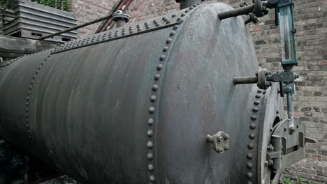 old vintage riveted cast iron industrial steam boiler outdoor