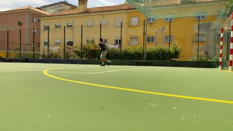 male tennis player hitting some balls forehand on a green clay court professional, lisbon, portugal