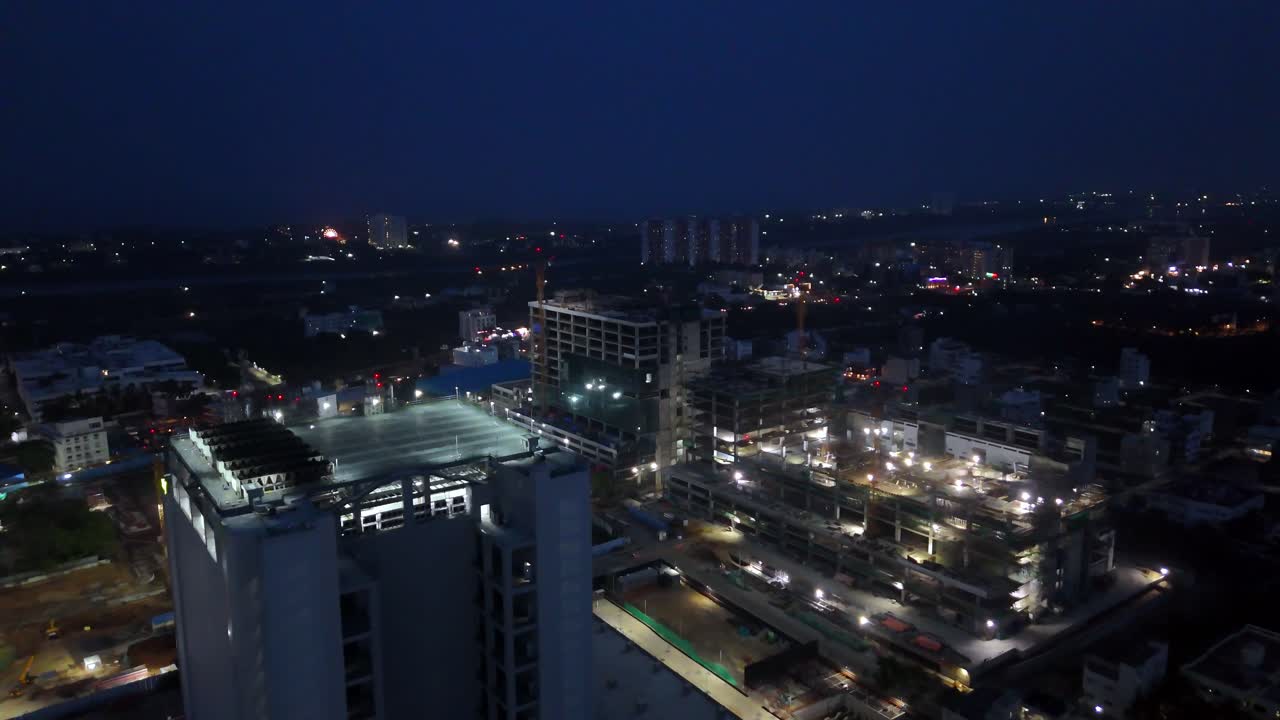 Aerial view of a bustling urban construction scene at night Indian city, Jubilant factory in Gajraula. modern buildings, with some still under construction and illuminated by numerous work lights.