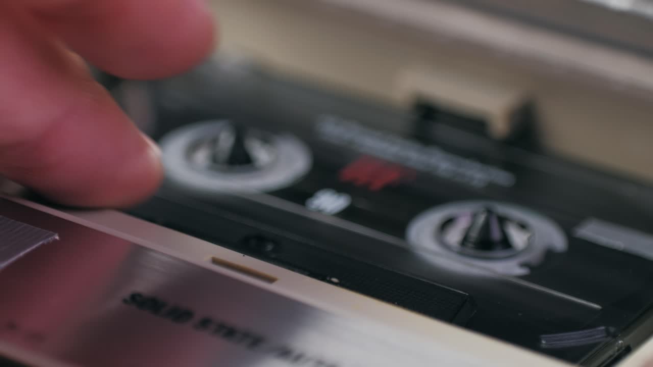 Inserting Audio Cassette into Tape Deck