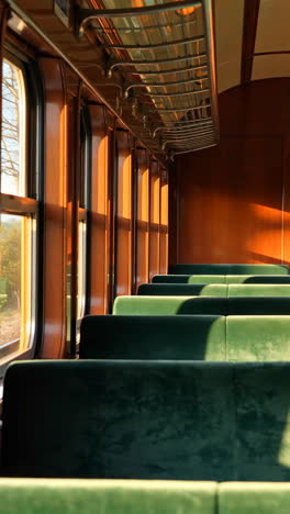 Empty Vintage Train Carriage with Sunlight Streaming Through Windows
