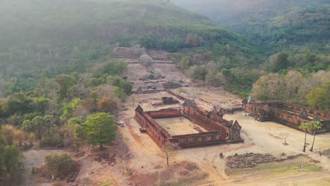 Vat-Phou,-Khmer-temple-drone-aerial-rotate-in-mystic-valley-surroundings