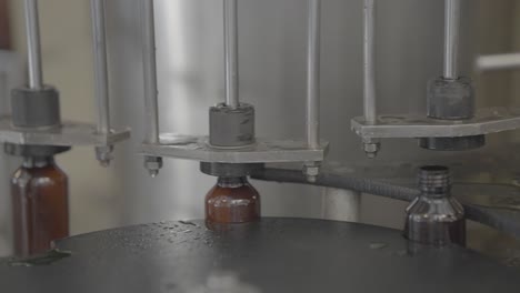 syrup bottles getting filled with liquid medicine close up shot slog footage.