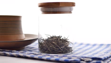 white tea in a glass jar with wooden lid