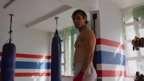 caucasian man standing in boxing ring