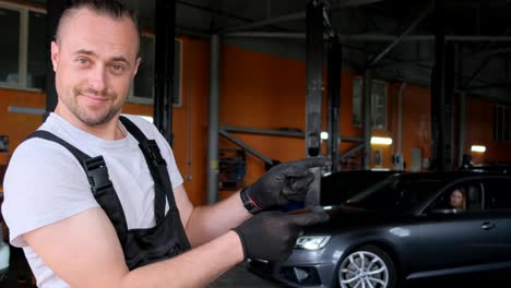 mechanic pointing in an auto service garage
