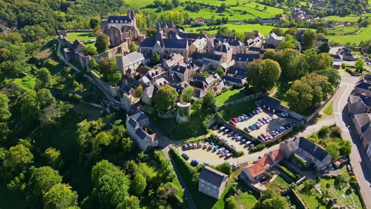 Sainte-Suzanne medieval city, castle, church, Mayenne, France. Aerial drone forward