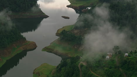 Drone-shot-of-Nepal's-misty-clouds-covering-lush-green-valley-in-Makwanpur