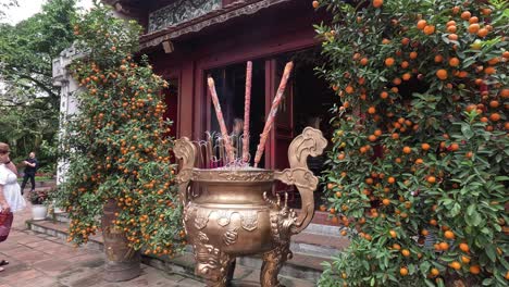 people visiting a temple with incense