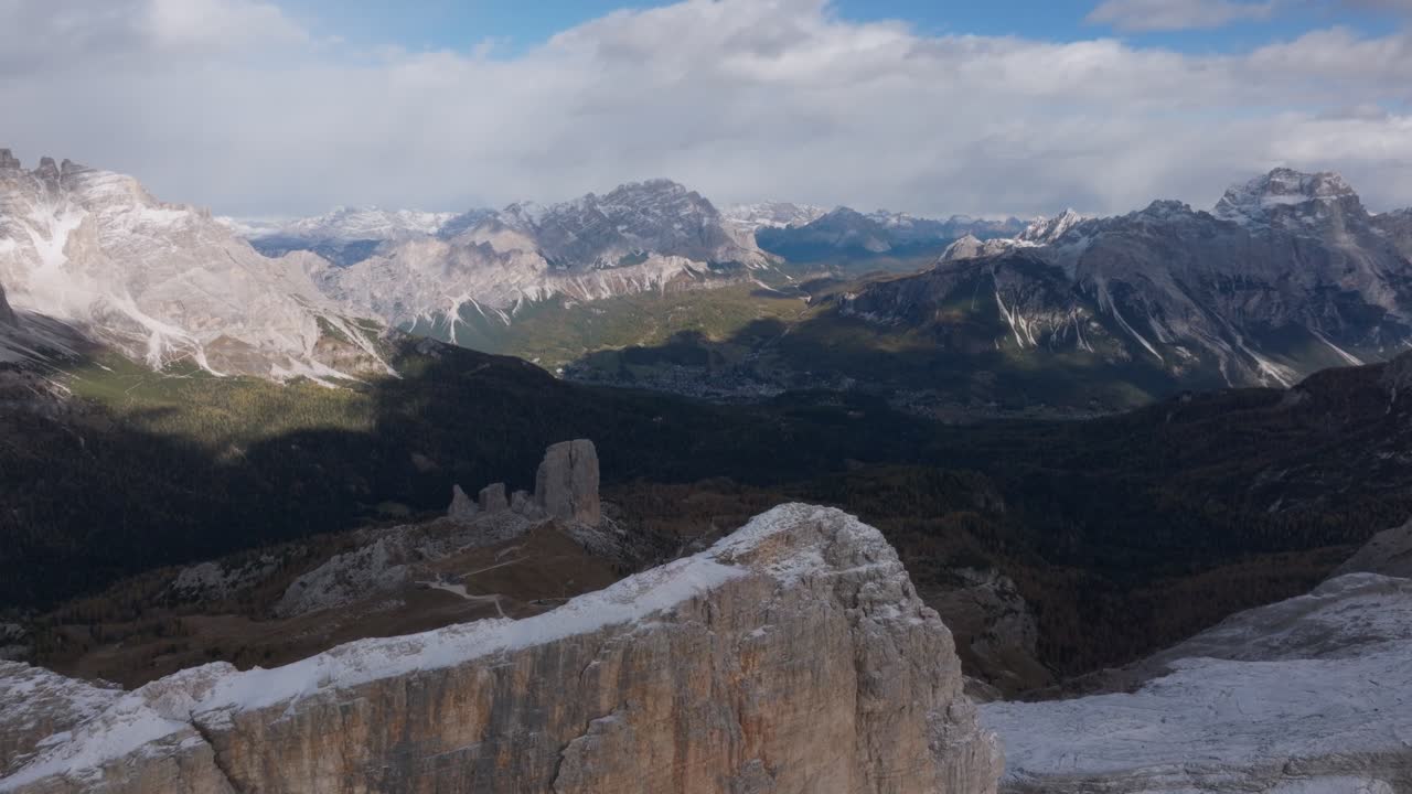 Aerial view of Cinque Torri as it gets revealed as the drone passes Monte Averau in the Italian Dolomites near Passo Falzarego