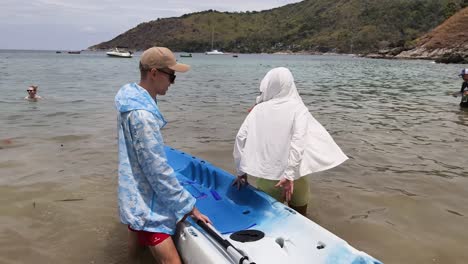 couple kayaking at beach