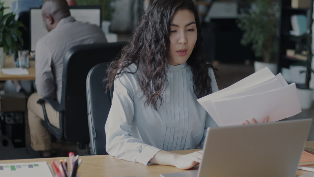 Woman Working on Laptop in Office