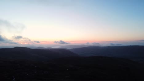 Silhouette-darkness-approaching-at-moorland-Kinder-Scout-England-aerial