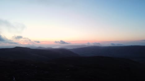 silhouette darkness approaching at moorland kinder scout england aerial