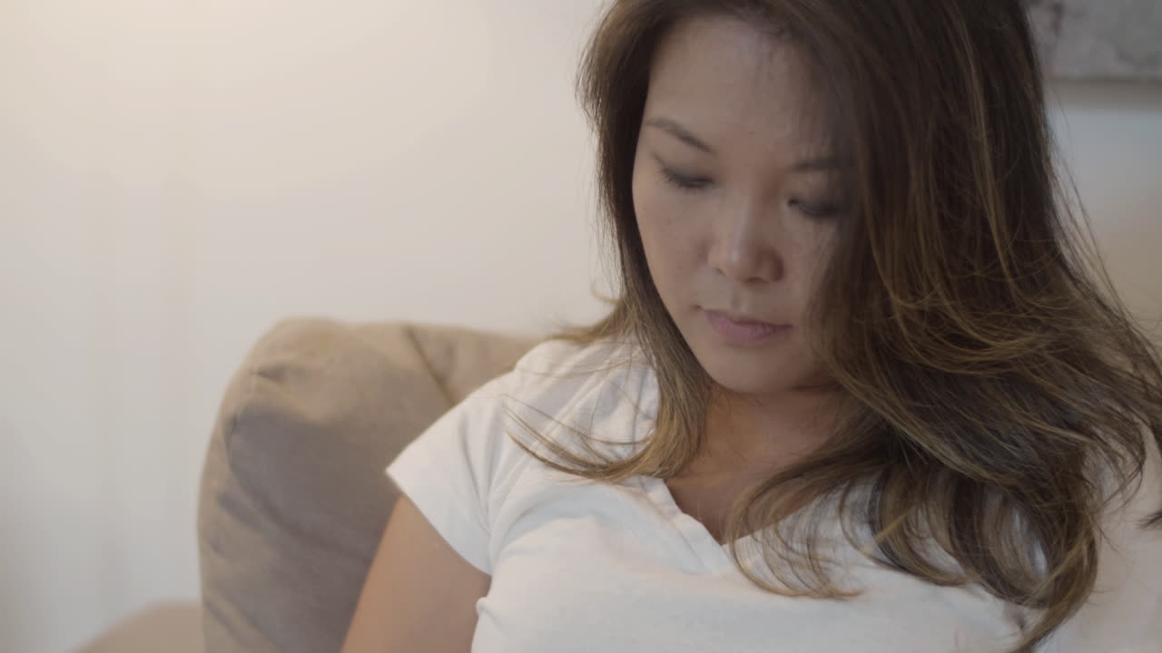 집에서 태블릿 화면을 보는 매력적인 여성의 중간  ⁇