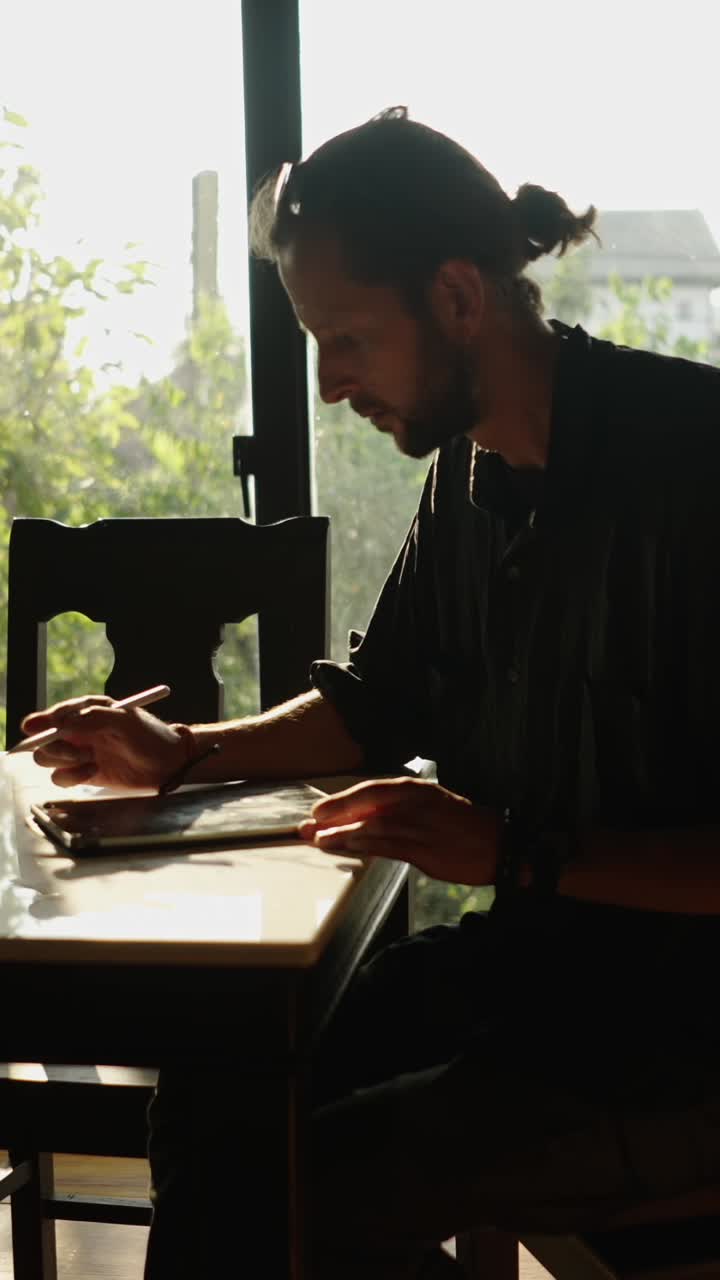 Man reading a book at a table