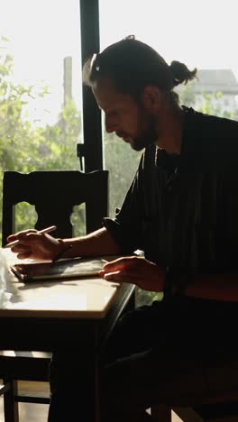 man reading a book at a table