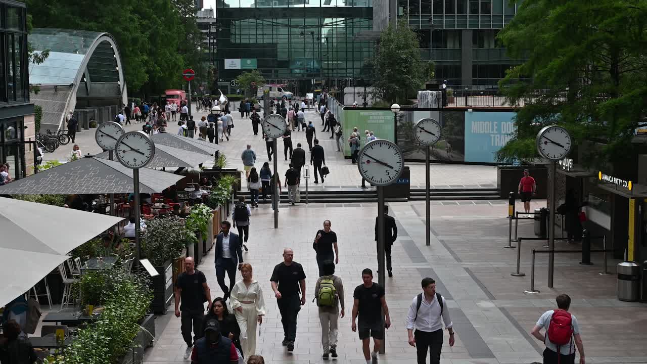 City street scene with pedestrians and clocks