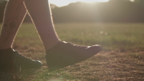 Man-Stretching-His-Legs-Before-a-Run-Whilst-Being-Silhouetted-By-The-Evening-Sun-In-Slow-Motion