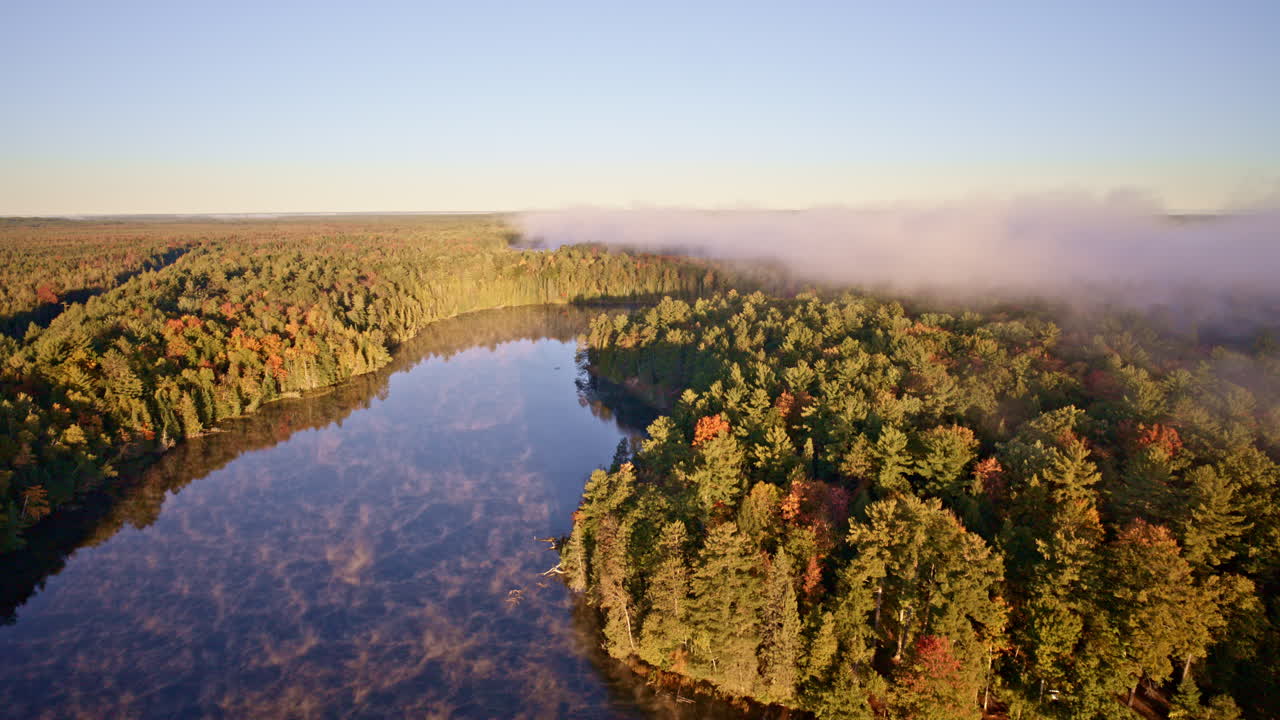 Cinematic perspective of water shedding mist as sunrise begins