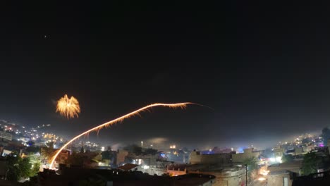 4k time lapse of the fireworks in the sky above the city during the diwali festival at night in wankaner, gujarat, india. fireworks in the sky background. festival concept.