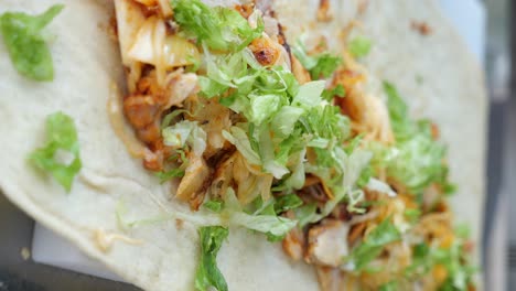 preparation of a chicken shawarma wrap with lettuce
