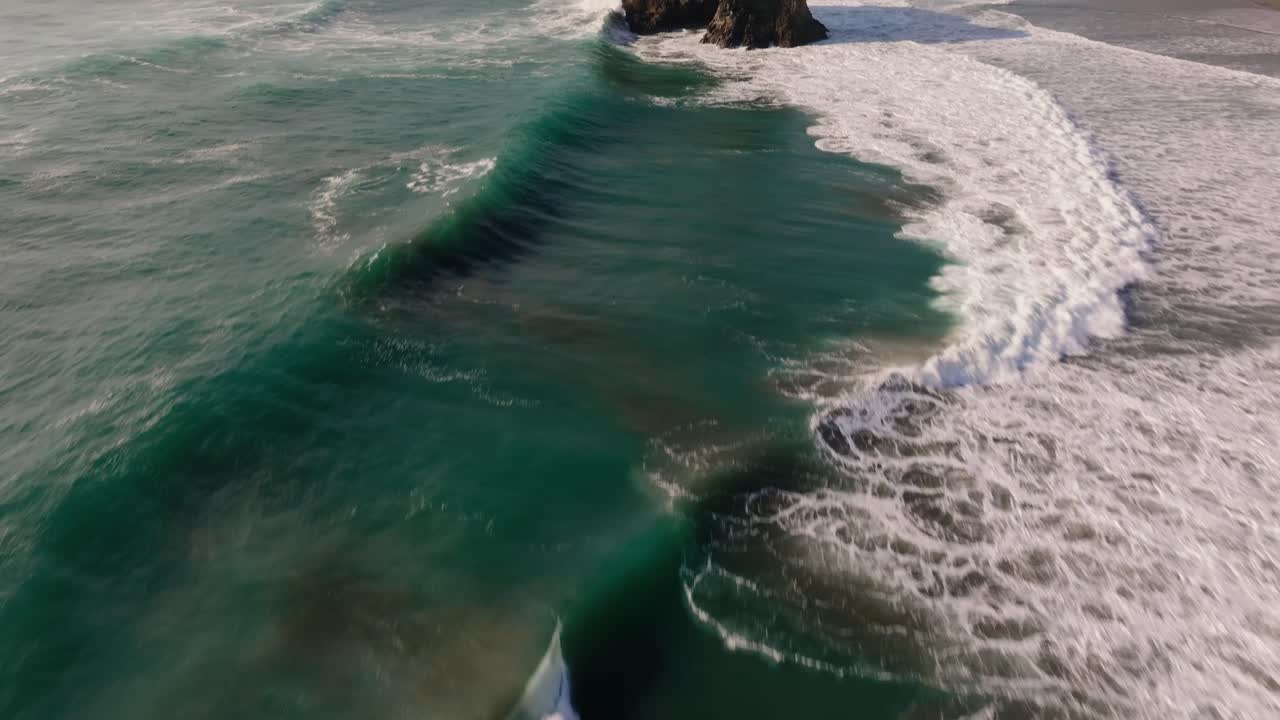 Aerial view of crashing waves along the California coast, USA, serene nature