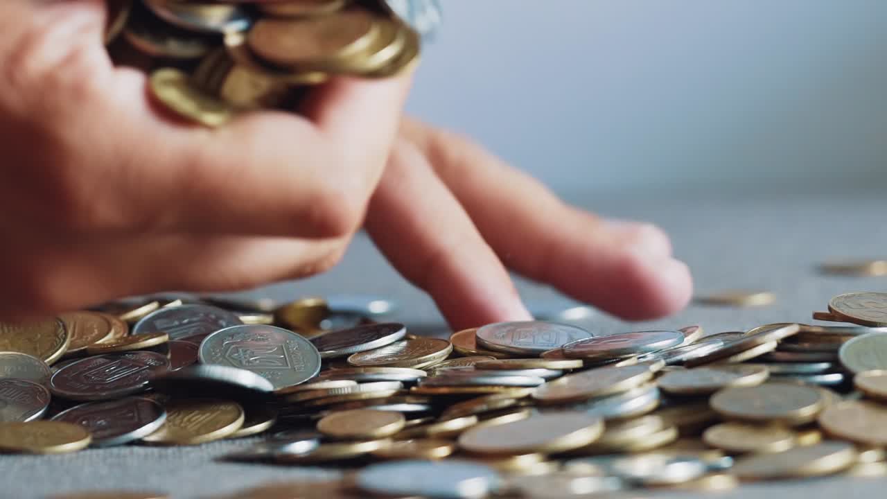 Man is holding coins in his hands. Man's hands hold a lot of gold coins. Financial, business concept.