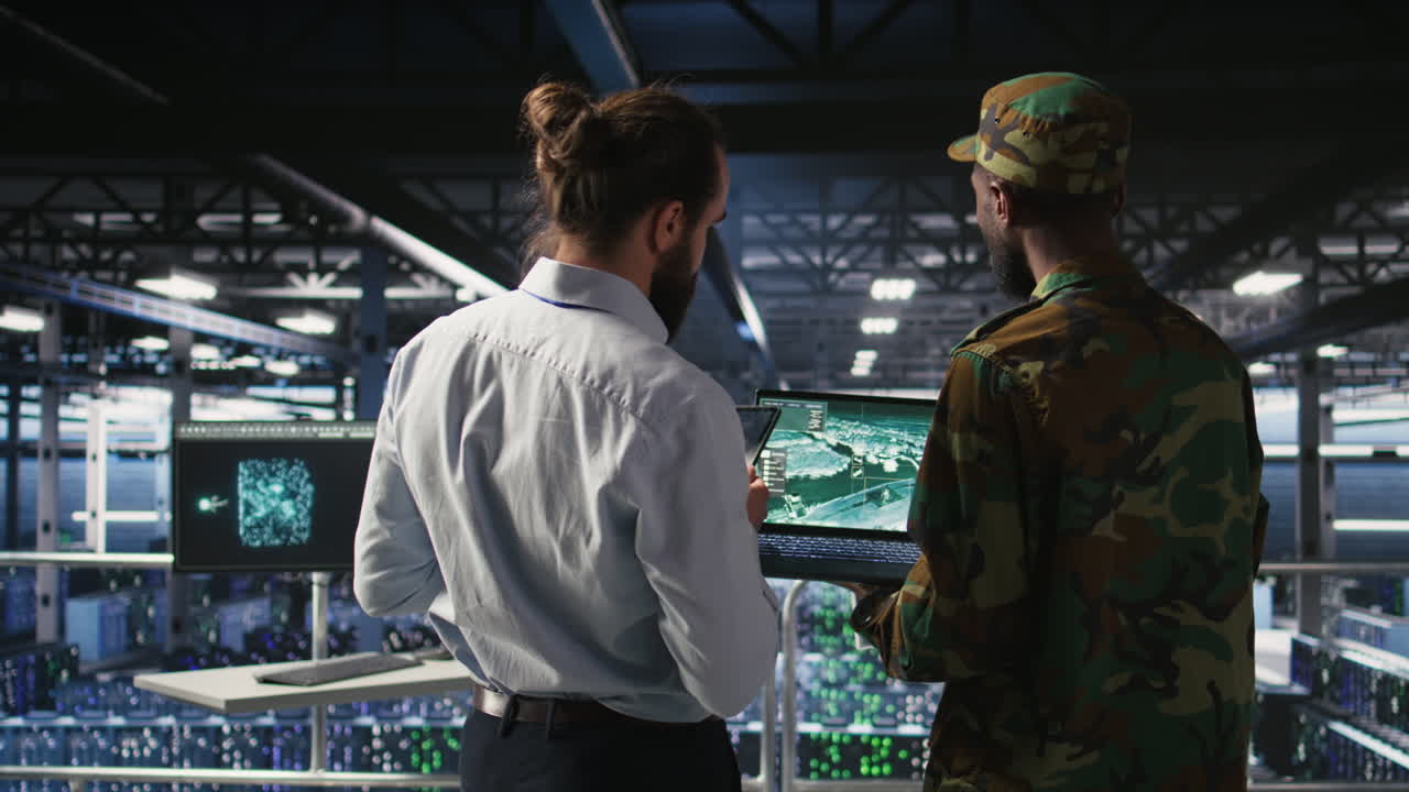 Army operators in data center using laptop to run drone control software