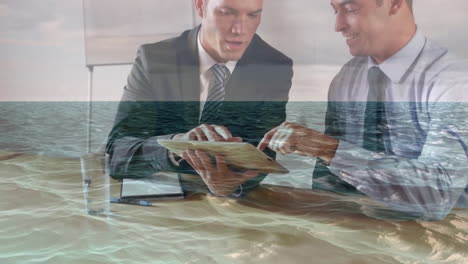 discussing business, businessmen using tablet with ocean waves animation overlay