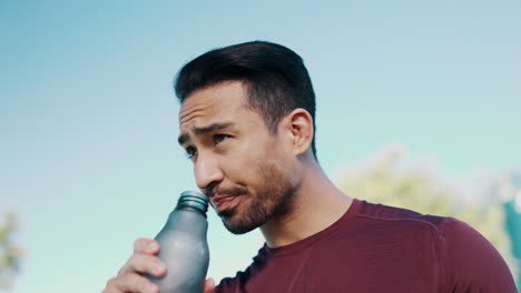 fitness, tired and outdoor man drinking water