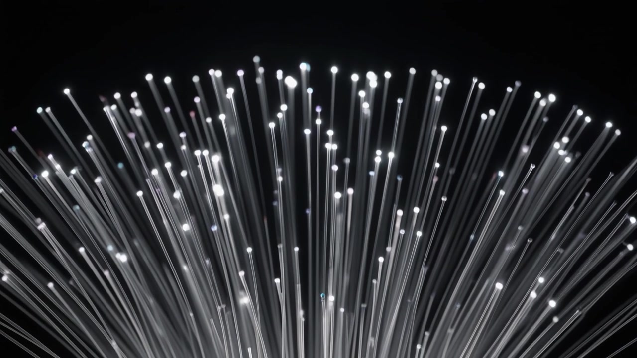 Glowing Fiber Optic Strands Against a Dark Background