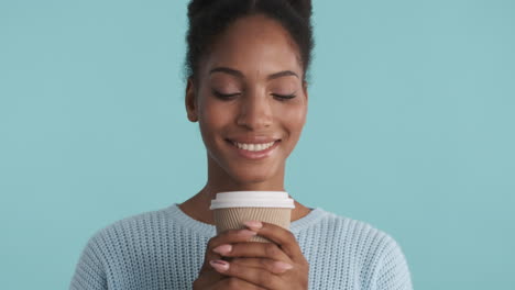 Smiling-girl-smelling-coffee-aroma