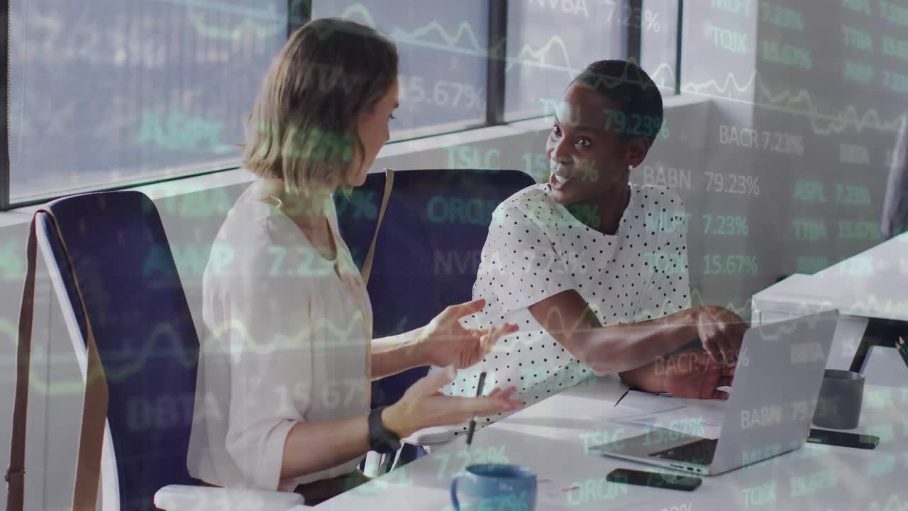Animation of financial data and graphs over diverse female coworkers in office