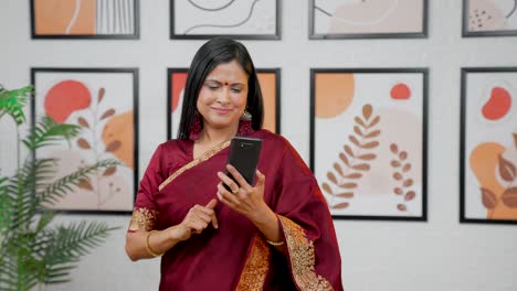 Happy-Indian-woman-using-phone