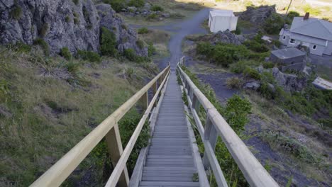 perspective shot descending a tall wooden staircase