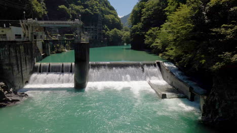 aerial over small dam and blue-green water in kochi prefecture on the island of shikoku, japan