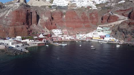 aerial drone video of beautiful bay of ammoudi below picturesque village of oia, santorini