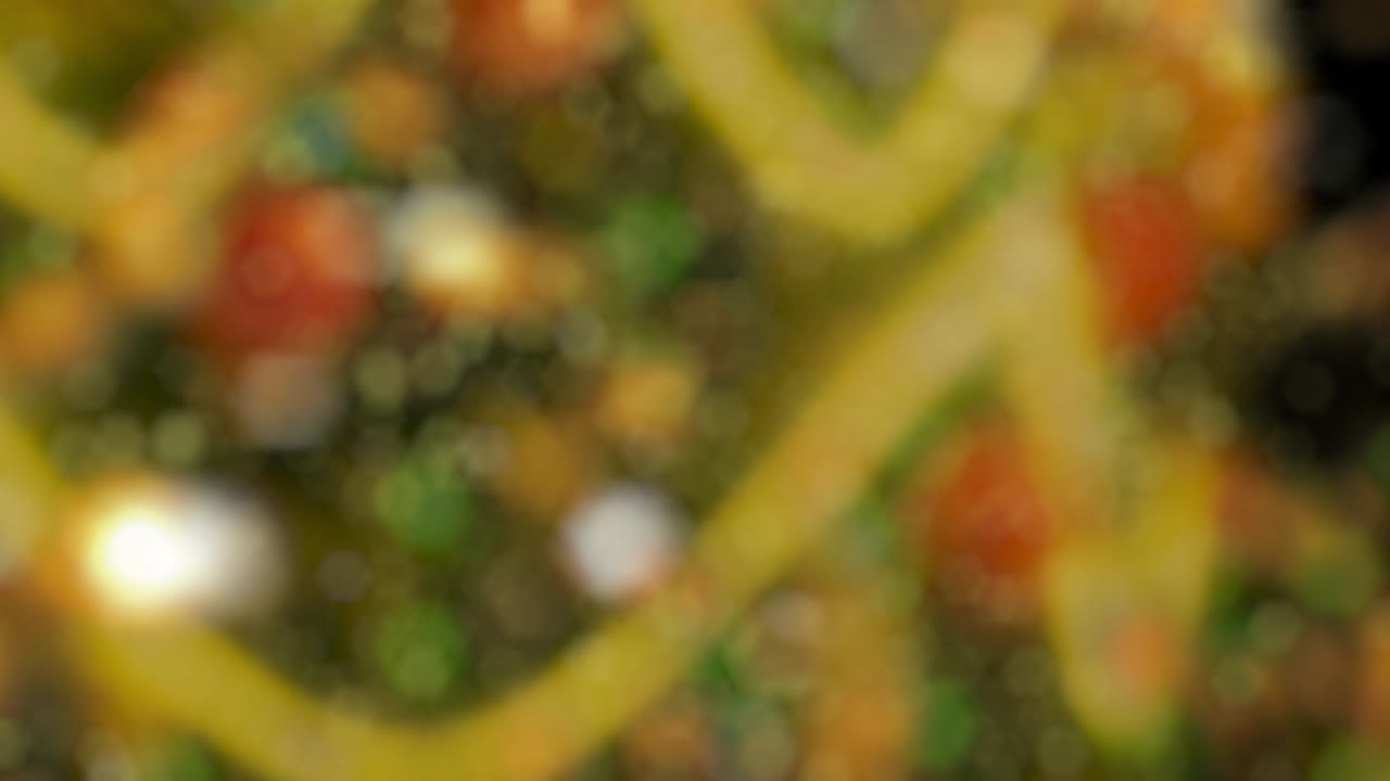 fondo de movimiento abstracto partículas de oro brillantes. partículas relucientes brillantes con bokeh. fondo de año nuevo y navidad. animación de video de bucle 4k sin costuras
