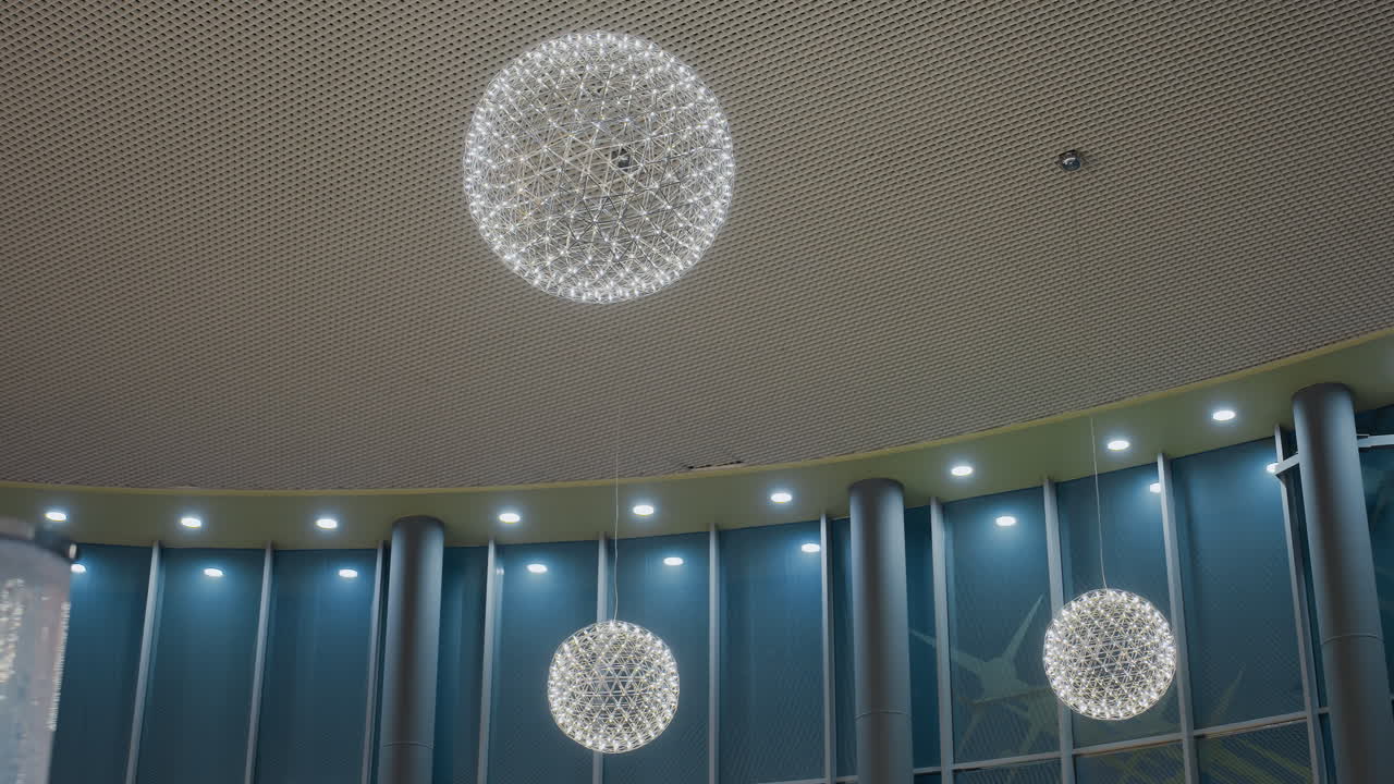 Beautiful decorative interior with elegant lighting and unique geometric chandelier design, soft glowing lights enhance modern, contemporary ambiance