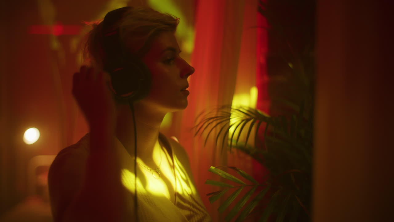 Woman Listening to Music in a Neon-Lit Room