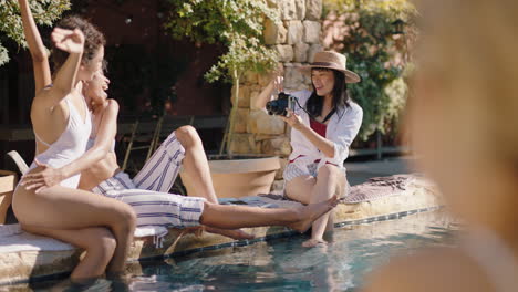 beautiful asian woman taking photo of friends relaxing by swimming pool enjoying sunny day on holiday girls having fun posing for camera making summer vacation memories 4k