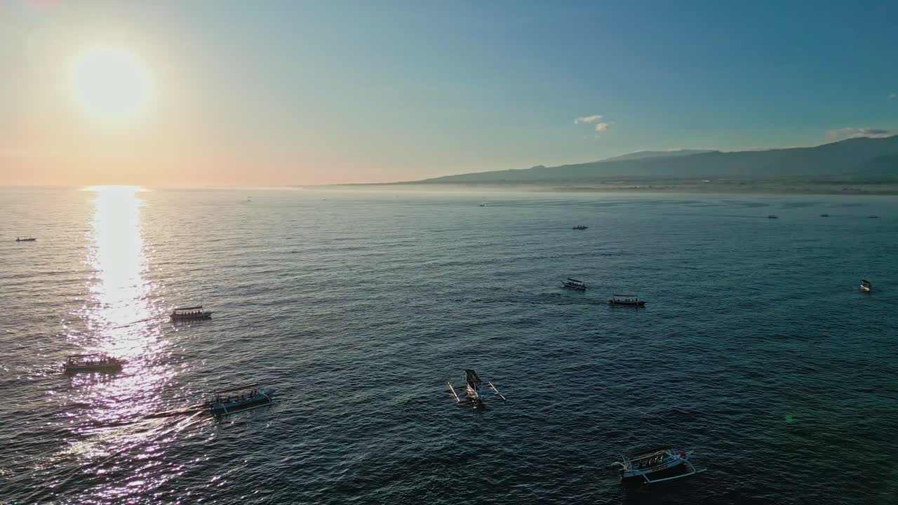 Fishermen’s wooden boats bring visitors close to wild dolphins under the morning light in Asia