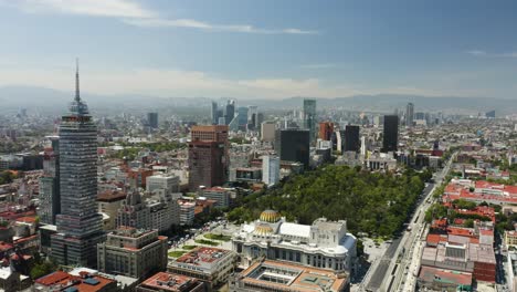 drone flies above palacio de bellas artes toward alameda central in mexico city