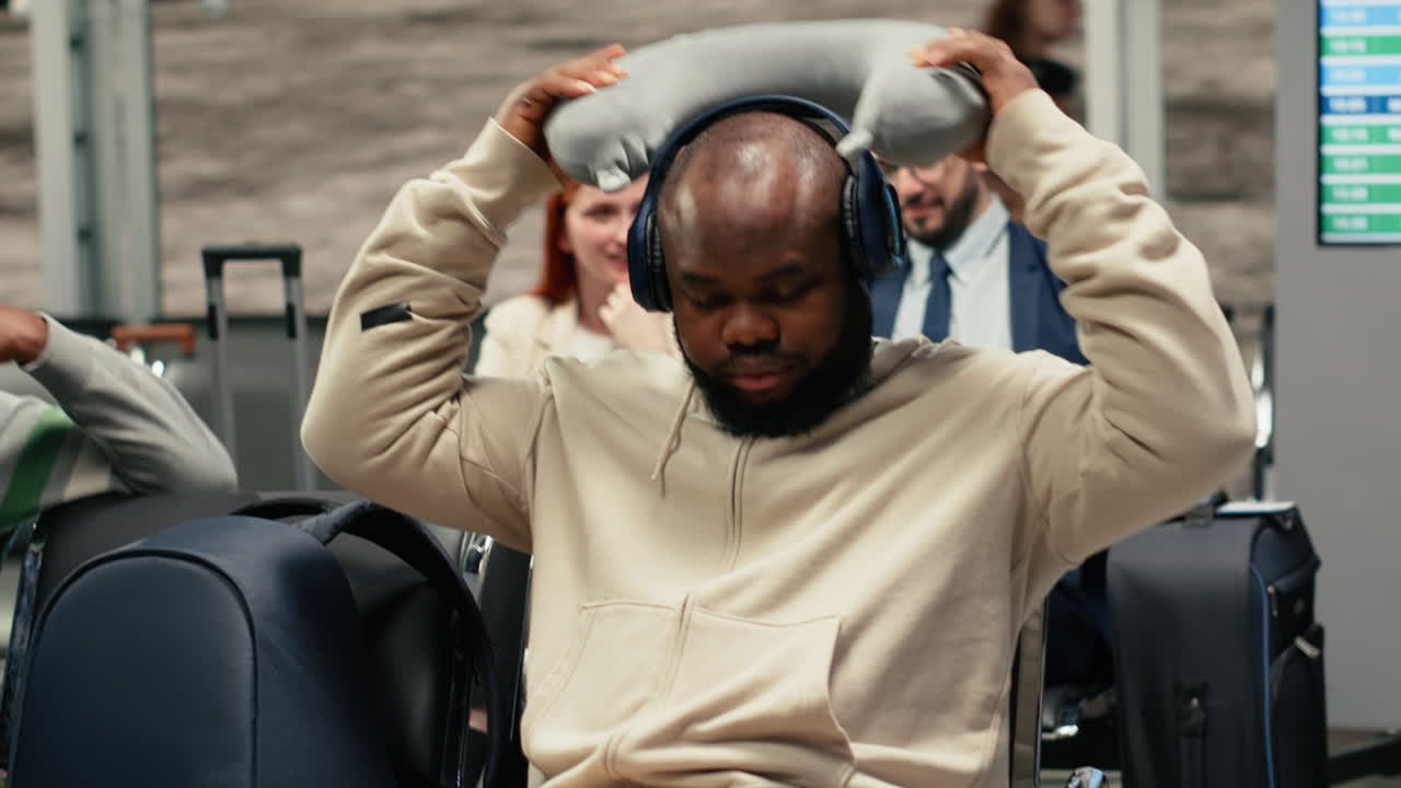 Listening music, smartphone and relaxed man in airport going to sleep