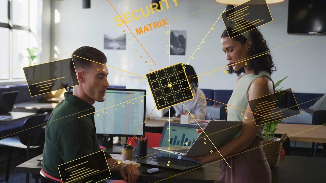 Woman holding laptop and man pointing, forming 3D security cube between colleagues showing security
